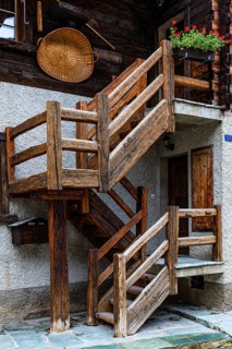 Wooden staircase on the outside of an old house in the historic village centre, Grimentz, Val