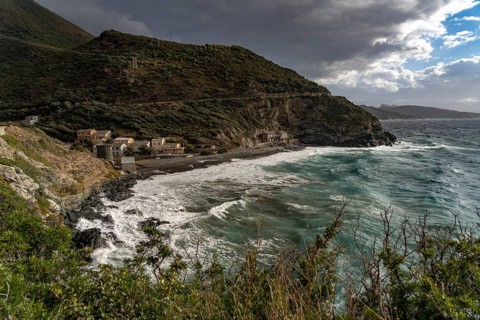 Beach and Genoese tower of La Marine de Negru on the west coast of Cap Corse, Corsica, France