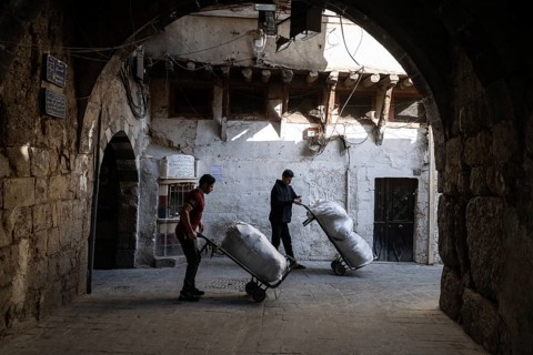 Damascus, Syria. December 4th 2025. Young Syrian men working in the narrow streets near Al