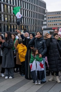 Syrian woman celebrate the end of the Assad regime after the change of power in Syria at a rally on