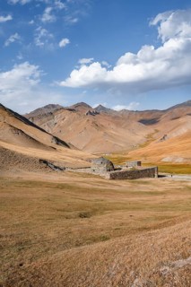 Historic caravanserai Tash Rabat from the 15th century, with yellow hills, Atbashy district in the