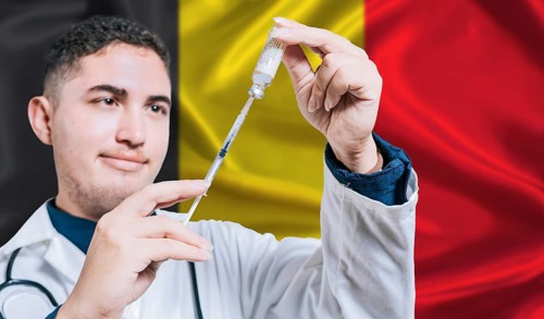 Doctor holding syringe on Belgium flag background. Medical professional holding syringe with