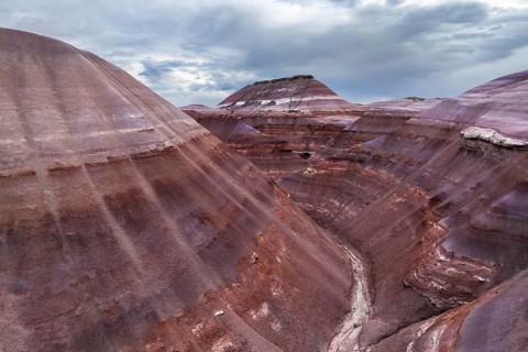 A stunning drone photograph capturing the layered geological formations unique to Hanksville, Utah,