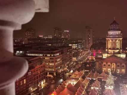 Night view over the roofs of the Christmas market on the Gendarmenmarkt of the festively