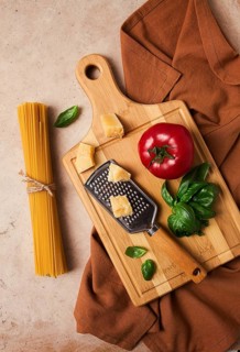 Raw pasta with ingredients on a beige background, top view, rustic style, selective focus, no