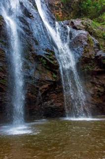 Water from the waterfall running over the rocks inside the rainforest in Minas Gerais, Brazil,