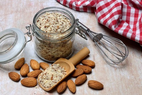 Almonds and ground almonds in glass, Prunus amygdalus