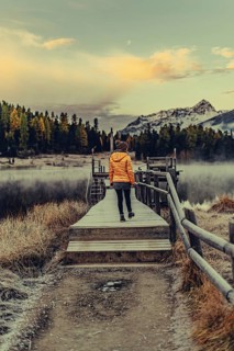 Young woman at Lake Staz near Sankt Moritz in the Engadine in Switzerland. Morning atmosphere with