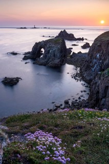 Coastal landscape at Land's End. The rock Enys Dodnan Arch with rock gate. In the foreground,