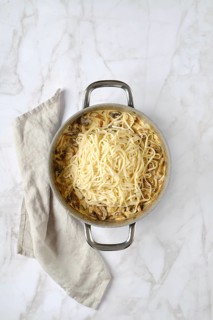Overhead view of casserole with noodles and chopped champignon, chanterelles, oyster mushrooms and