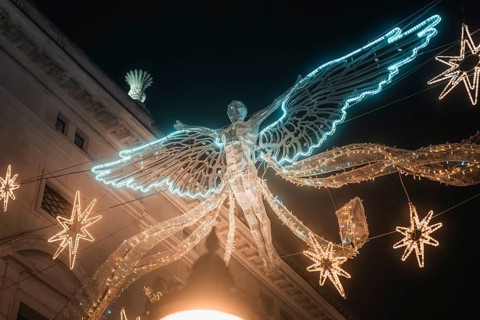 Shining angel and stars form festive Christmas decoration, New Year's Eve London, United Kingdom