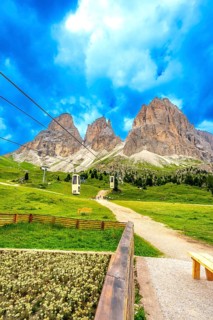Cable cars transporting tourists up the scenic sella pass in the dolomites, italy, during a