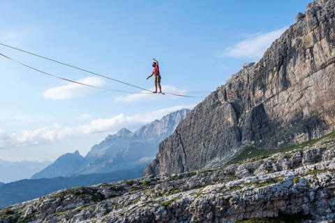 Slackliner in the mountains, mountain peaks of the Brenta Mountains, at Refugio Francis Fox