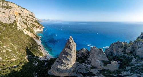 Picturesque rocky coast, cliffs with L'Aguglia pinnacle, blue sea and Cala Goloritzé beach, aerial