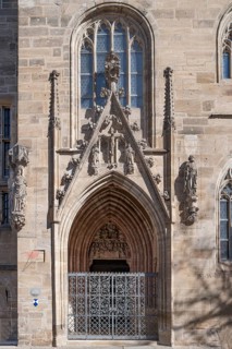 Gothic side entrance portal with the tympanum of the Entombment of Mary, St Andrew's Church,