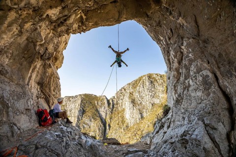 A man is engaging in mountaineering and rappelling activities at Eagleâ€™s Nest, Monterrey, Mexico.