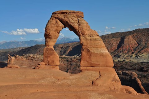 Delicate Arch, a beautiful natural rock arch in the middle of an extensive desert landscape, Arches