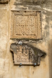 Weathered stone slab on a wall with an ancient inscription in Italian, Galatina, Apulia, Italy