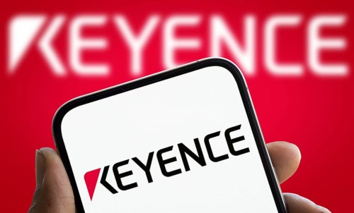 Keyence logo is displayed on smartphone. Keyence is a Japanese company that manufactures automation