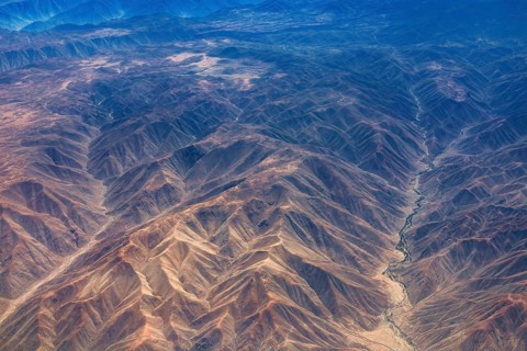 Breathtaking mountain formations in an arid desert region seen from the air, the landscape and