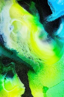A dynamic abstract composition of swirling green, yellow, and blue inks. The vibrant textures and