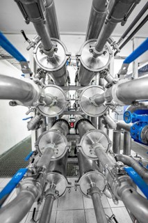 Symmetrical arrangement of metal pipes and valves in an industrial environment, ENCW Netze Calw