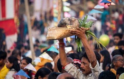 Hindu devotees gather on the banks of the Brahmaputra River to offer prayers to the Sun God on the