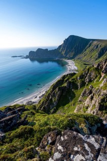 View of coastal landscape, cliffs with peak Måtind or Måtinden, Høyvika beach and sea, hike to the