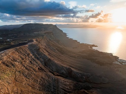 Cliffs by the sea in evening light, steep cliffs on the coast near the Mirador del Porrito, aerial