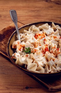 The dish features a generous serving of Turkish dumplings topped with velvety yogurt and a drizzle