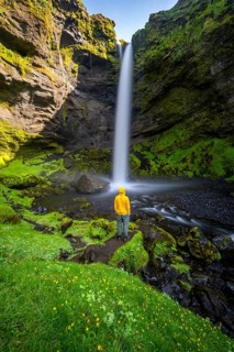 Tourist at Kvernufoss waterfall, in summer when the weather is nice, gorge and river, long