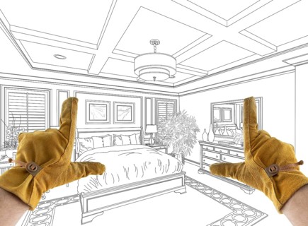 Male Contractor Hands Framing Over Custom Master Bedroom Design Drawing