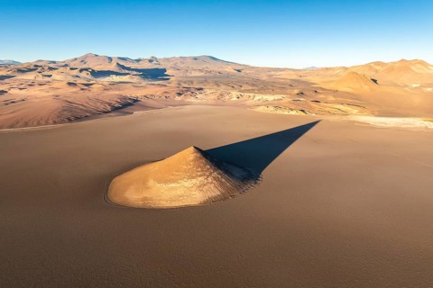 From above, the Cono de Arita in Salta, Argentina forms a striking natural landmark amidst the