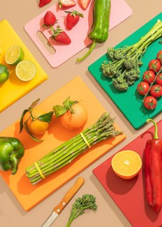 A colorful display of fresh fruits and vegetables on bright cutting boards, showcasing ingredients
