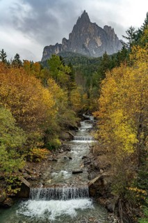 Autumn at the Schwarzgriesbach stream and the Schlern mountain in Seis am Schlern, South Tyrol,
