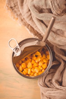Open tin can, with corn, top view, selective focus, no people, close-up