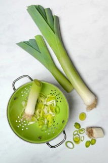 Leek, leek sticks and leek rings in a sieve bowl