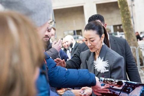 Michelle Yeoh signs autographs ahead of the premiere of the film Everything Everywhere All At Once