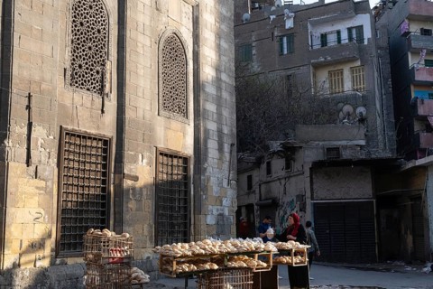 Cairo, Egypt. April 15th 2025. An Egyptian women sells freshly baked Baladi flat bread from a