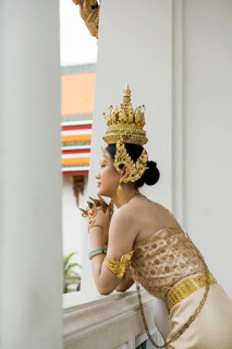Thai traditionally and festively dressed young woman, Wat Pho, Bangkok, Thailand
