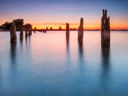 View at sunset over the Strelasund of the skyline of the city of Stralsund with its churches and