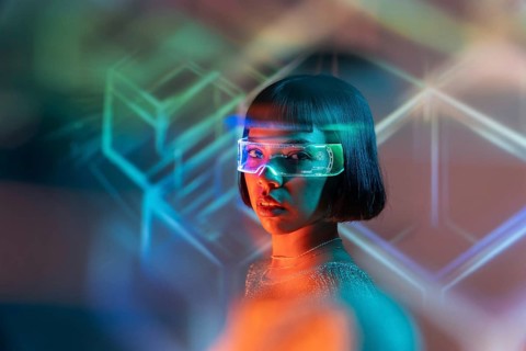 A Latin woman wearing futuristic virtual reality glasses explores a digital world. The colorful