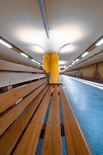 Modern underground station with yellow columns and bright lighting, Hamburg, Germany