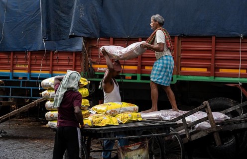 GUWAHATI, INDIA - MAY 1: Labourers carries goods in a wholesale market, in Guwahati, India, on May