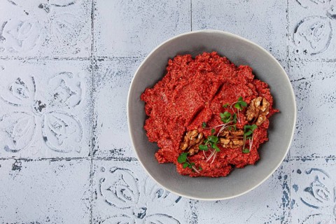 Mahammara red pepper sauce, with walnuts, and sprigs of fresh microgreens, homemade, no people
