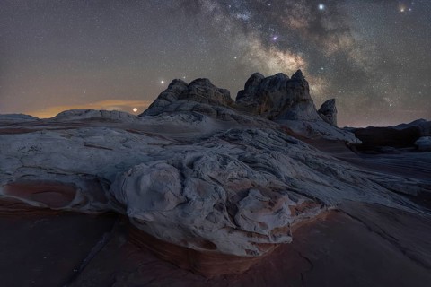 A breathtaking view of Utah's desert landscape under a star-studded Milky Way. No people in this