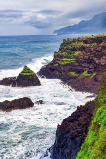 Cliffs, rocky beach and Atlantic Ocean in rainy weather, Seixal, Madeira, Portugal
