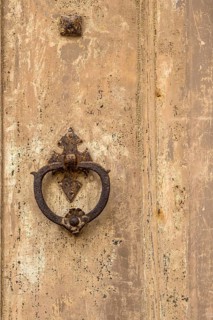 Door knocker on an old wooden gate, Galatina, Apulia, Italy