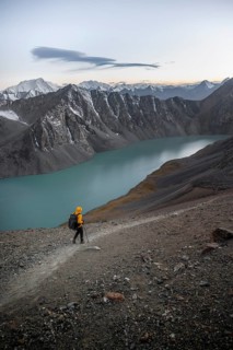 Mountaineer at Ala Köl mountain lake, in the Tien Shan Mountains, near Altyn Arashan, Kyrgyzstan