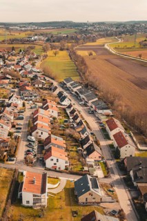 View of a rural residential development with single-family houses and surrounding fields, Ötisheim,